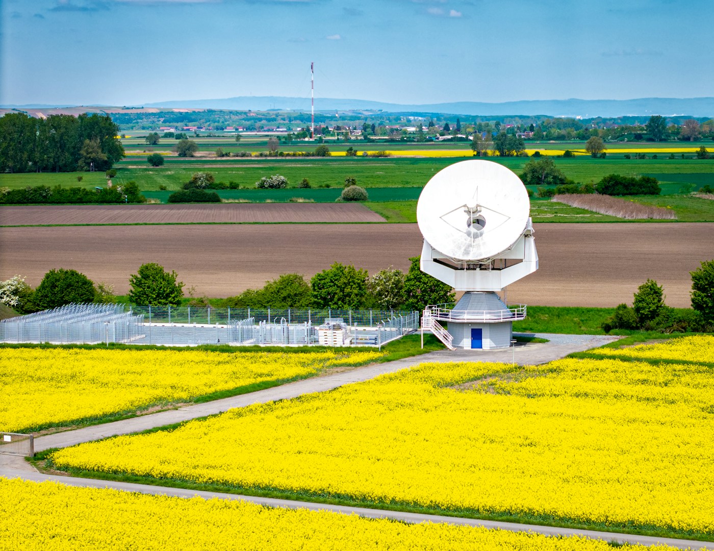 Satellite communications infrastructure alongside agricultural fields